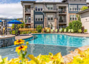 Thumbnail 20 of 38 - Pool With Sun Deck and Lounge Chairs at Avena Apartments, Thornton, Colorado