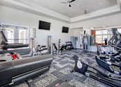 Thumbnail 18 of 32 - A spacious gym with a variety of exercise equipment at the Talavera at the Junction.