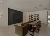Thumbnail 26 of 85 - A modern living room with a bar area and a television.