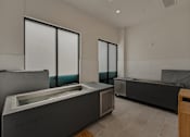 Thumbnail 22 of 85 - A modern room with a large window and a hot tub.