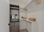 Thumbnail 12 of 85 - A white closet with a shelf and a basket on it.
