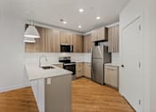 Thumbnail 16 of 85 - A modern kitchen with wooden cabinets and stainless steel appliances.