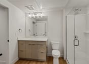 Thumbnail 11 of 85 - A white bathroom with a toilet, sink, and mirror.