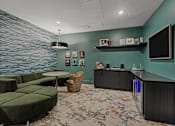 Thumbnail 46 of 85 - Speakeasy community room with couches and mini fridge