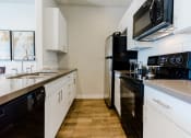 Thumbnail 24 of 61 - Modern Black & White Kitchen at Parc at Day Dairy Apartments and Townhomes, Draper, UT