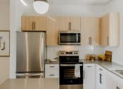 Thumbnail 12 of 61 - Gourmet Kitchen with Modern Appliances at Parc at Day Dairy Apartments and Townhomes, Utah, 84020