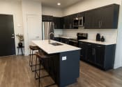 Thumbnail 10 of 29 - Kitchen with an Island at The Arza, American Fork 84003