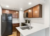 Thumbnail 2 of 22 - Kitchen with Black Appliances at Rio Seco Apartments