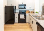 Thumbnail 7 of 39 - Kitchen with Black Appliances at The Reserve at View 78