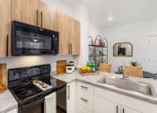 Thumbnail 1 of 16 - Kitchen with Black Appliances at The Veridian