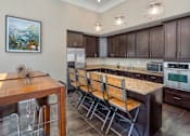 Thumbnail 10 of 32 - Kitchen with Brown Cabinets in the CLubhoue at the Talavera