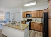 Thumbnail 3 of 31 - Kitchen with Island at San Tropez