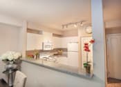 Thumbnail 6 of 30 - Fitted Kitchen With Island Dining at Metropolitan Place Apartments, Washington