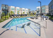 Thumbnail 11 of 39 - Lounge chairs in pool at The Austin Townhomes