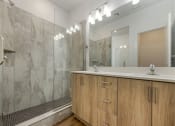 Thumbnail 16 of 27 - Primary Bathroom with Double Vanity and Walk-in Shower at Desert Sage Townhomes, Utah, 84737