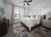 Thumbnail 9 of 41 - Primary Bedroom with a Ceiling Fan at Parc View Apartments and Townhomes Midvale, UT 84047