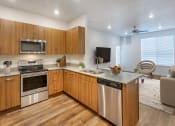 Thumbnail 5 of 25 - Kitchen with Steel Appliances at Meadows at Homestead Logan, UT 84321