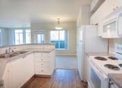 Thumbnail 5 of 40 - Kitchen With White Cabinetry And Appliances at Metropolitan Collection Apartments, Washington