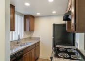 Thumbnail 4 of 28 - Kitchen with granite countertops and a black stove top oven