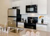 Thumbnail 27 of 61 - Modern Kitchen at Parc at Day Dairy Apartments and Townhomes, Draper, Utah