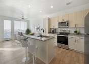 Thumbnail 6 of 14 - Kitchen with Living Room in One Bedroom Apartment at City Lofts