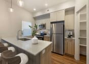 Thumbnail 8 of 27 - Kitchen with a Large Pantry at Desert Sage Townhomes Hurricane, UT 84737