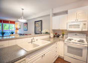 Thumbnail 14 of 30 - Energy Efficient Electric Range In Kitchen at Metropolitan Place Apartments, Renton, WA, 98057
