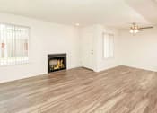 Thumbnail 10 of 20 - Living Room with Fireplace and Woodgrain Flooring at River Oaks Apartments & Townhomes, California