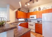 Thumbnail 4 of 23 - Fully Equipped Kitchen at Canyon Ridge Apartments, Surprise, AZ