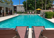 Thumbnail 17 of 23 - Poolside Relaxing Area at Canyon Ridge Apartments, Arizona, 85378