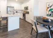 Thumbnail 11 of 41 - Kitchen with Woodgrain Floor at Parc View Apartments & Townhomes, Utah, 84047