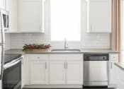 Thumbnail 6 of 39 - White Cabinetry In Kitchen with Stainless Steel Appliances at Rivulet Apartments, American Fork, UT