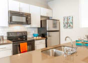 Thumbnail 2 of 39 - Kitchen With Stainless Steel Appliances at San Tropez Apartments & Townhomes, Utah
