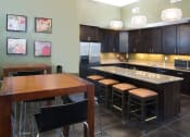 Thumbnail 31 of 38 - Clubhouse Kitchen Breakfast Bar with Stools at Talavera at the Junction Apartments & Townhomes, Utah, 84047