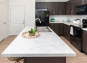 Thumbnail 7 of 38 - Kitchen with Large Island at Garden Lofts Apartments, Utah, 84101