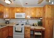 Thumbnail 4 of 18 - Heritage Park Senior Apartments Kitchen & Desk - Norco CA
