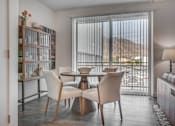 Thumbnail 17 of 45 - A dining room with a table and chairs.
