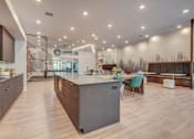 Thumbnail 28 of 45 - A modern kitchen with a large island and wooden floors.