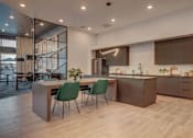 Thumbnail 29 of 45 - A modern kitchen with a dining table and chairs.
