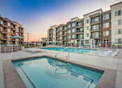 Thumbnail 32 of 45 - A swimming pool in front of apartment buildings.