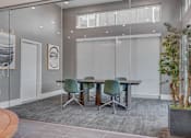 Thumbnail 41 of 45 - A conference room with a glass table and chairs.