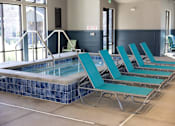 Thumbnail 15 of 34 - A pool with blue tiles and a metal ladder.