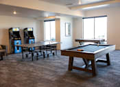 Thumbnail 27 of 34 - A room with a pool table and two arcade machines.