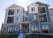 Thumbnail 31 of 34 - A modern two-story residential building with balconies and large windows.