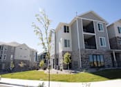 Thumbnail 33 of 34 - A modern two-story building with a stone facade and large windows.