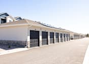 Thumbnail 34 of 34 - A long row of houses with garages on the side.