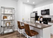 Thumbnail 16 of 56 - Kitchen with Island in Phase I TH at Parc at Day Dairy