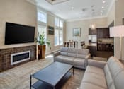 Thumbnail 13 of 32 - A modern living room with a fireplace and a large couch at the Talavera at the Junction