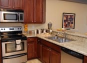 Thumbnail 24 of 40 - upgraded kitchen with granite countertops at Metropolitan Collection Apartments, Renton, 98057