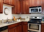 Thumbnail 23 of 40 - upgraded kitchen with stainless steel appliances at Metropolitan Collection Apartments, Renton, WA, 98057